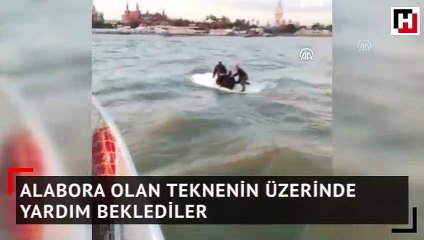 Alabora olan teknenin üzerinde yardım beklediler