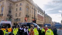 Moment Just Stop Oil protester scales up Met Police van during demo