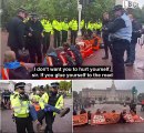 Moment young police officer politely asks eco-mob causing rush hour chaos, 'what their plans are' and if they 'have any questions' as they sit glued to the road - before police FINALLY move in to arrest 25