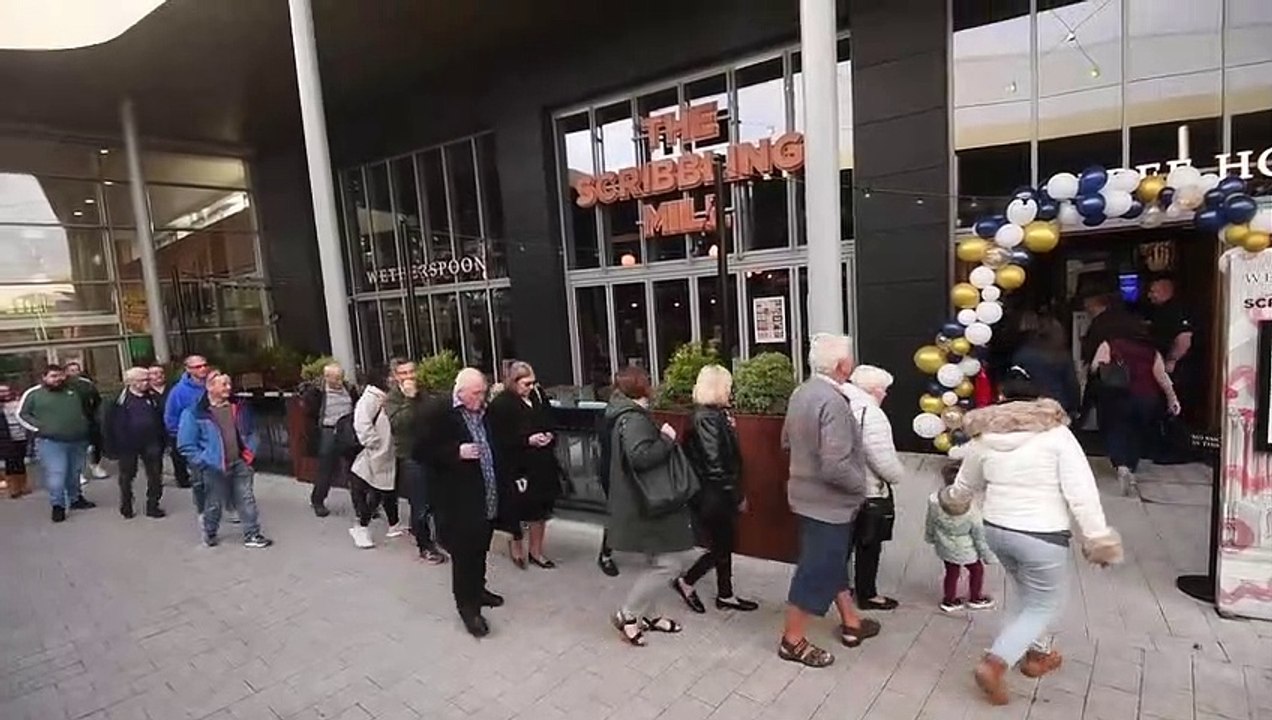 Customers queue to get the first drinks at the new Wetherspoons pub the Scribbling Mill at the White Rose Centre