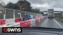 Hilarious footage shows a confused motorist cruising along barricaded section of dual carriage
