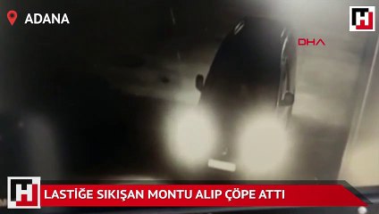 Lastiğe sıkışan montu alıp çöpe attı