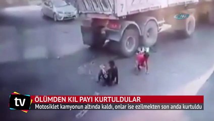 İki çocuk kamyonun altında ezilmekten kıl payı kurtuldu