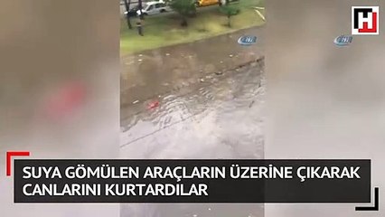 Suya gömülen araçların üzerine çıkarak canlarını kurtardılar