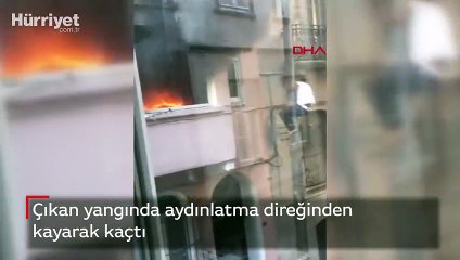 Çıkan yangında aydınlatma direğinden kayarak kaçtı