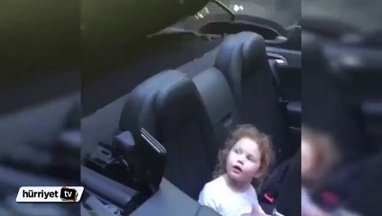 Otomobilinin üzerini kapatırken kızını korkutan baba