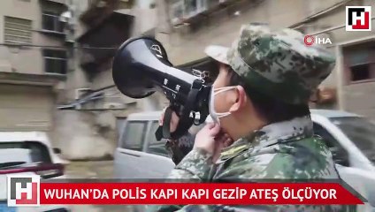 Wuhan’da polis kapı kapı gezip ateş ölçüyor
