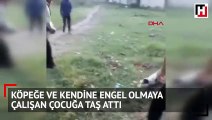 Köpeğe ve kendine engel olmaya çalışan çocuğa taş attı