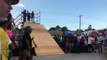 Skateboarder goes up half pipe and falls on the back of his head