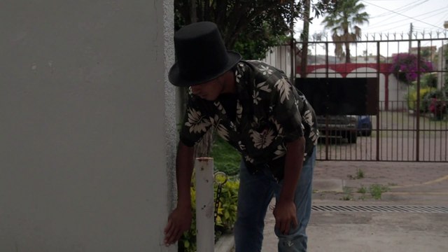 Skateboarder rides down roof of house then crashes into wall