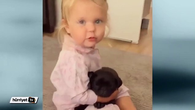 Köpeğinin uyuması için ona şarkı söyleyen küçük kız