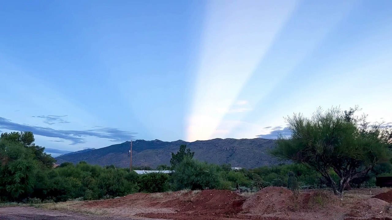 Light Beam From Setting Sun Shoots Across Sky