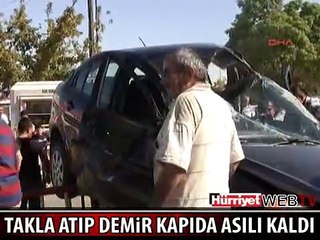 TAKLA ATAN OTOMOBİL DEMİR KAPIDA ASILI KALDI