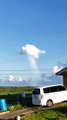 Rainbow Appears to Pour Out of Cloud