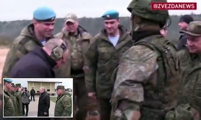 Putin dresses all in black and shows off his prowess with a sniper rifle as he joins defence chief Sergei Shoigu on first visit to training camp for mobilised Russians