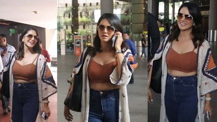 Sunny Leone spotted at Mumbai airport, was seen busy in Phone, Watch video | FilmiBeat