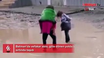 Vefakar abla göle dönen yolda kardeşini sırtında taşıdı