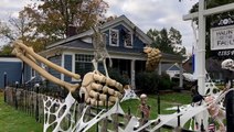 Halloween enthusiast decorates house with 30ft skeleton arms to celebrate spooky holiday
