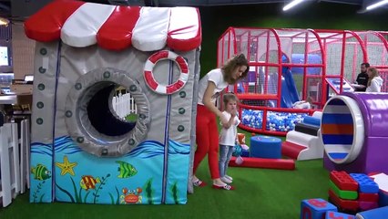 Eva and Mom Have Fun Together on the Indoor Playground for Children