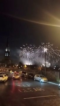 Derry cityscape and sky lit up in brilliant Hallowe'en fireworks finale as St. Eugene's Cathedral stands sentinel