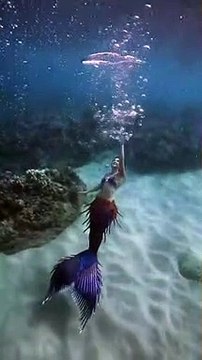 Blowing bubble rings underwater as a real life mermaid