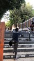Skateboarder attempts to grind handrail then falls forward and lands on stomach