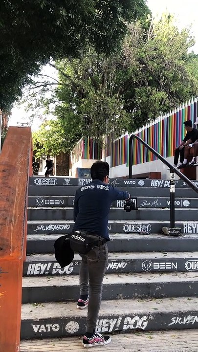 Skateboarder attempts to grind handrail then falls forward and lands on stomach