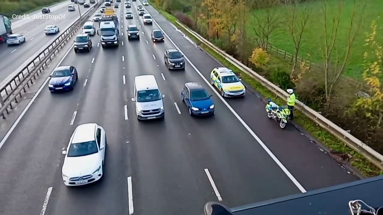 A Just Stop Oil protester abused by motorists