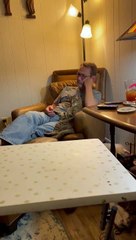 Cat and Dad Hold Hand and Paw While Watching TV