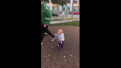 Mom unintentionally records the infant's first steps on camera.