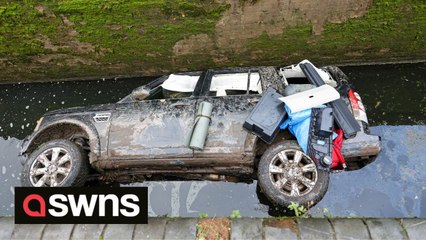 A stretch of canal has been closed after a CAR was mysteriously found submerged by water in a lock