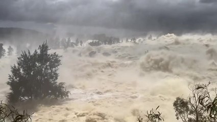 Roaring water spills over dam after heavy rainfall in New South Wales