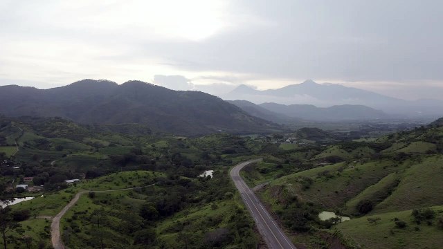 Road surrounded by mountains Road surrounded by mountains and nature on a cloudy and foggy day.