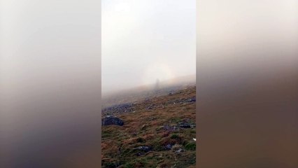 Walker captured moment he spotted a "ghostly figure" hiking alongside him in the mountains