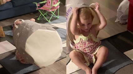 Happy-go-lucky little girl hides in a laundry bag