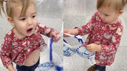 Baby girl sets her sights on buying a bra for herself while shopping with mom