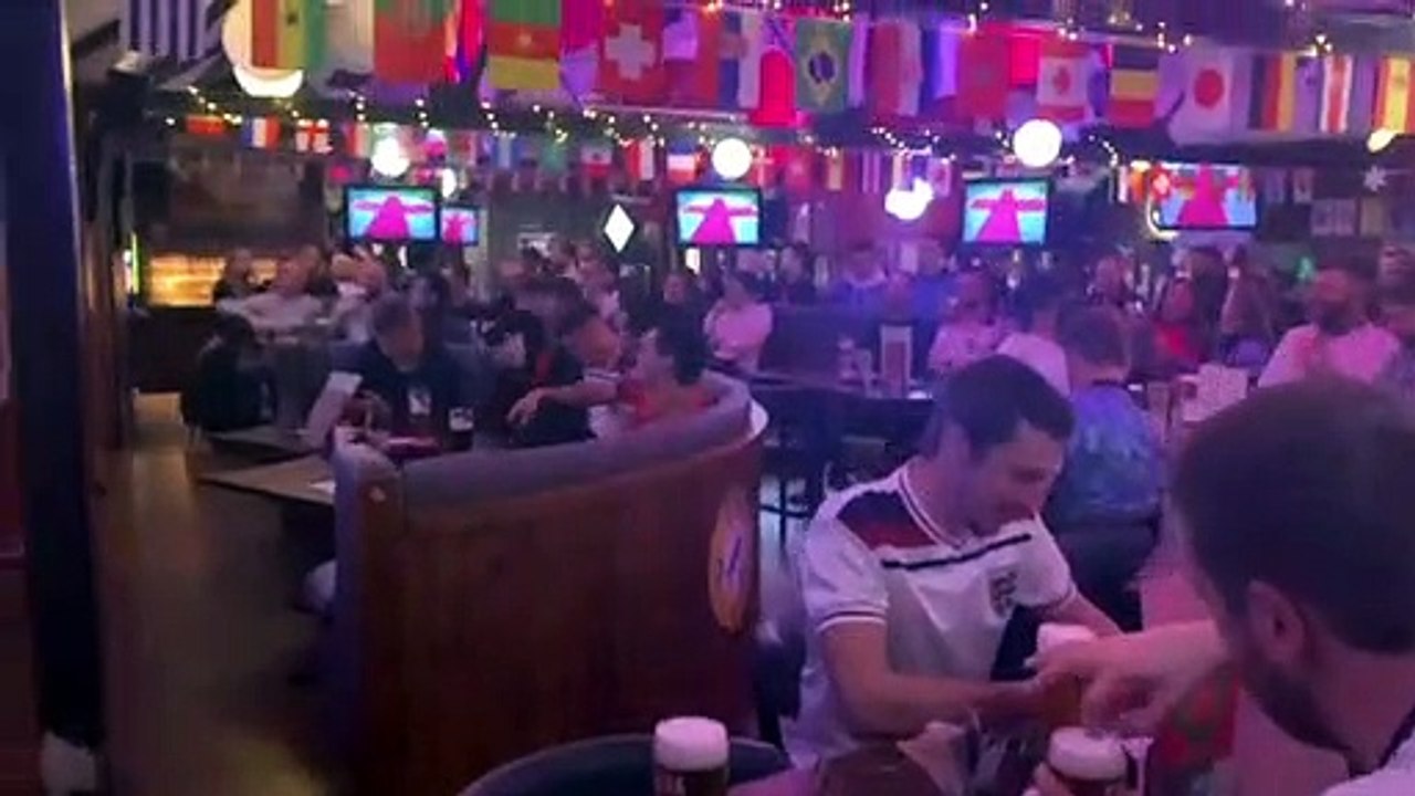 England fans at The Common Room in Sheffield sing God Save the King before the opening World Cup game against Iran.