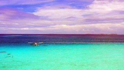 Pemandangan - pantai - mixkit-water-plane-in-a-paradise-sea-2877-medium