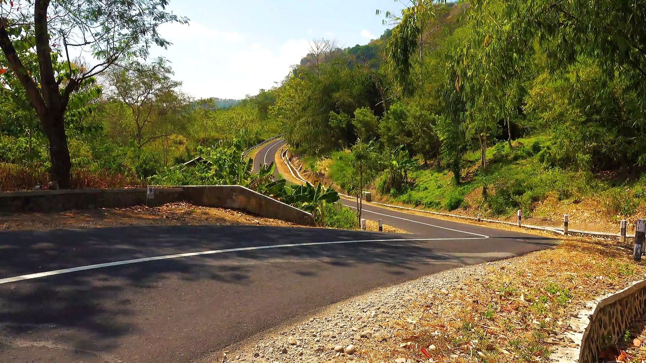 Motorcycle Riders Speeding On A Long And Winding Road
