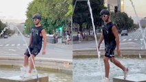 A man fails to jump in fountain and covers his fail with confident walk!