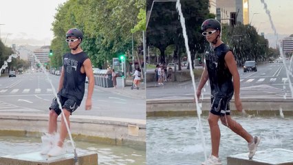 A man fails to jump in fountain and covers his fail with confident walk!