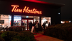 Customers queue outside Tim Hortons as restaurant opens its doors