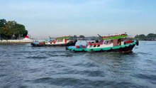 Tugboats pulling a huge barge at Koh Kret Chao Phraya river