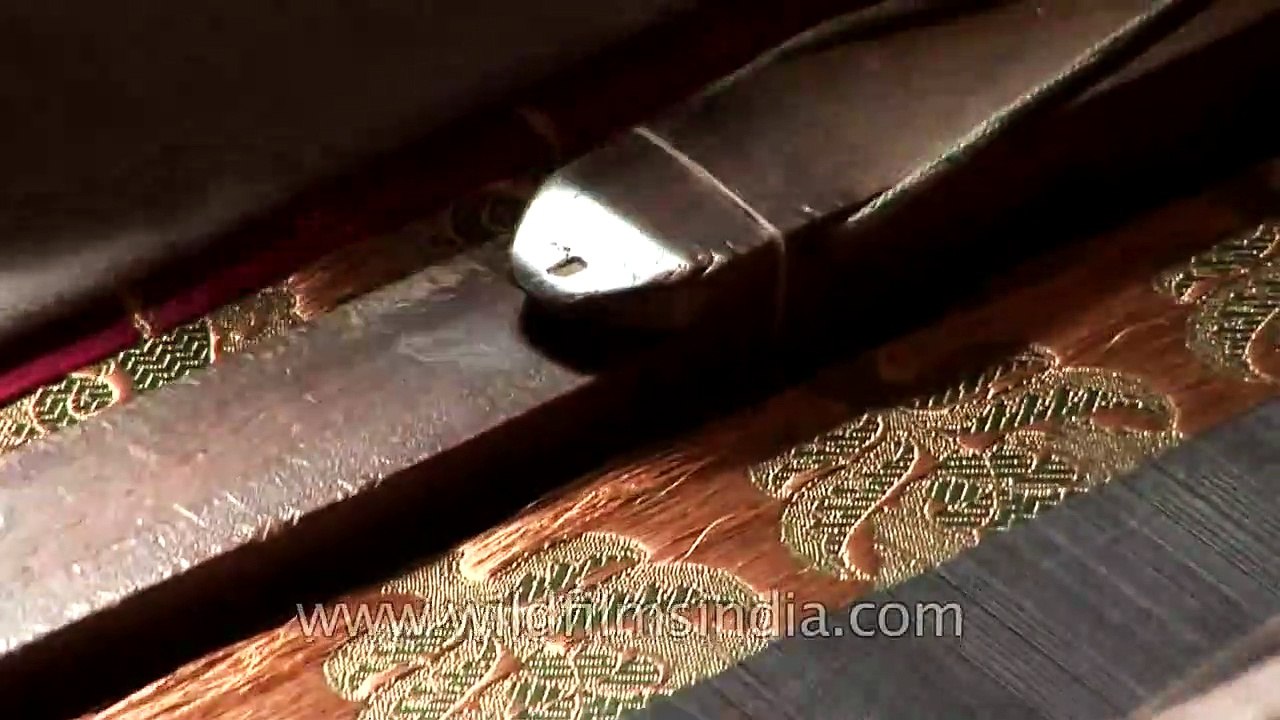 Artisan weaves a Banarasi saree using a traditional weaving machine
