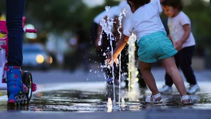 it's nice to see children playing in the water on the street