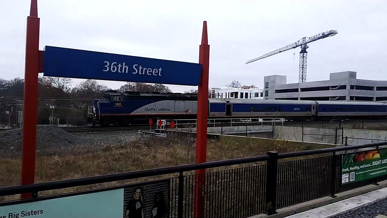 North Carolina By Amtrak Piedmont Train Speeds Past 36th Street Light Rail Station