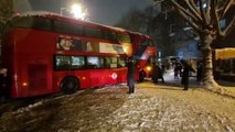 Video shows Londoners banding together to move a double-decker bus that got stuck during heavy snowfall