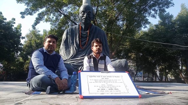 Civil Defense Forum on silent fast under the statue of Mahatma Gandhi in Hanumangarh Collectorate Park