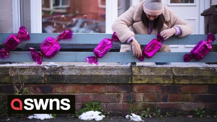 Residents of Britain's 'real-life Quality Street' adorn their homes with sweet decorations to raise money