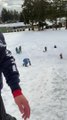 Catching Air Sledding Down a Snowy Slope